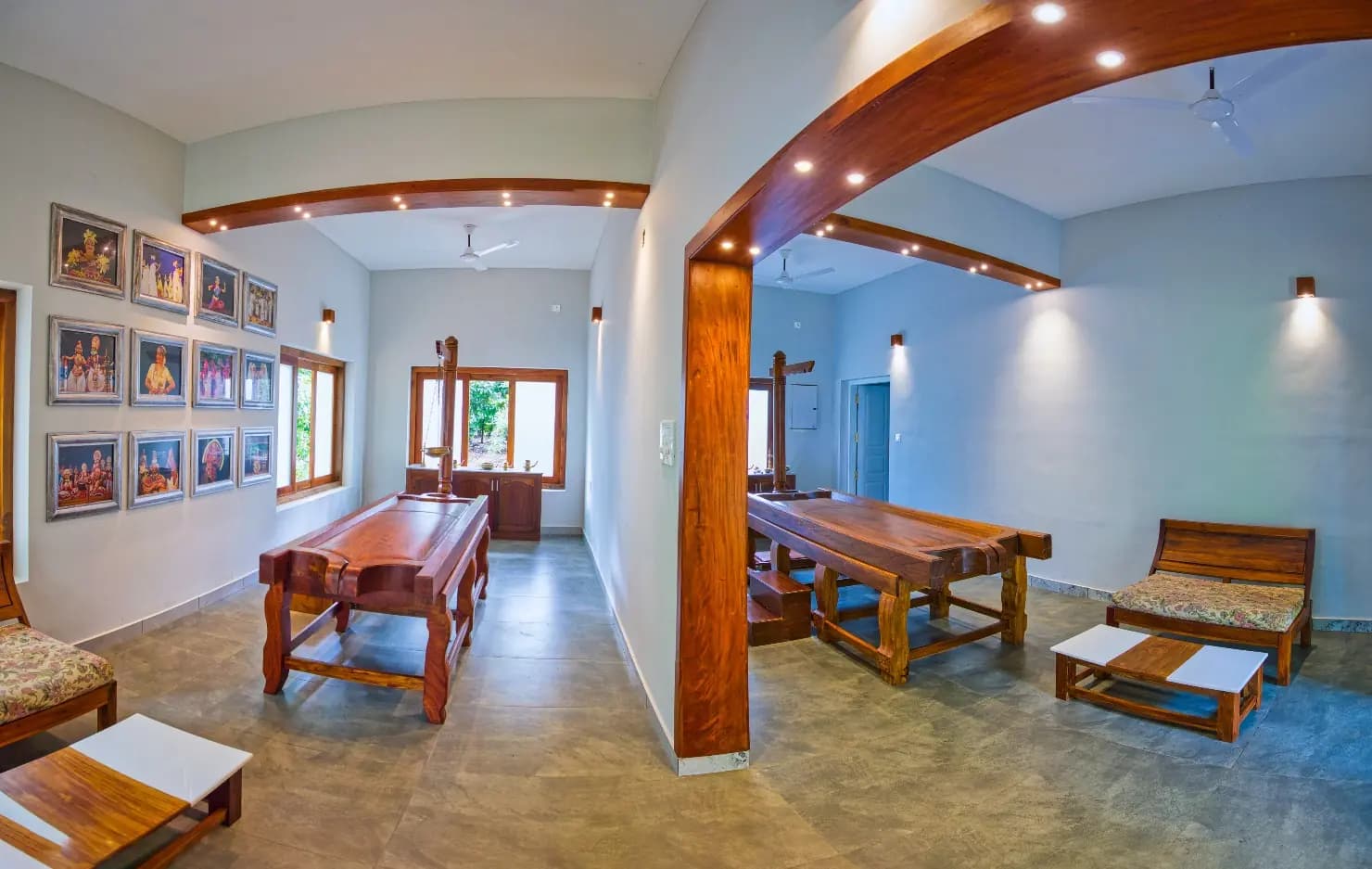 Dining hall with wooden tables beside an indoor courtyard garden at an Ayurveda retreat in Kerala